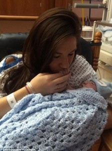 Jenna kisses the hand of newborn Shane