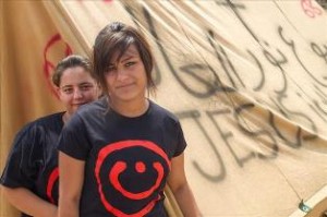 Christian teens in Erbil next to tent saying "Jesus Christ is the Light of the World"