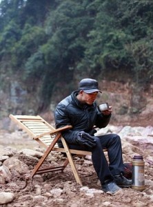 Huang Yuanfeng sitting at construction site 