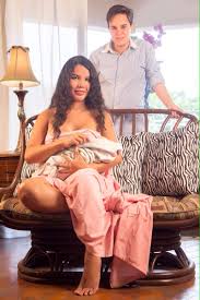 Diane Rodriquez (seated) and Fernando Machado with newborn son