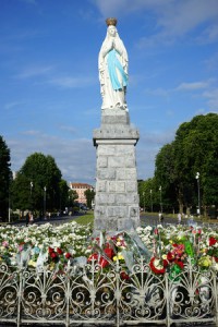 50648881 - lourdes, france - circa july 2015 statue madonna and flowers
