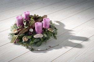 23875380 - advent wreath of twigs with purple candles and various ornaments