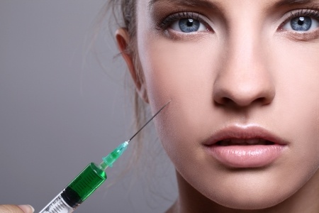 16999113 - close up of beautiful woman gets an injection in her face