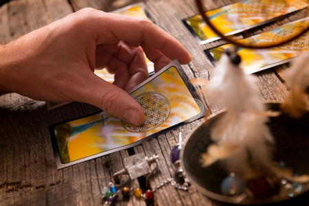 51029175 - fortune teller holding a tarot card
