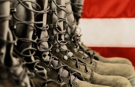 7711721 - sage green military combat boots with us flag in the background.