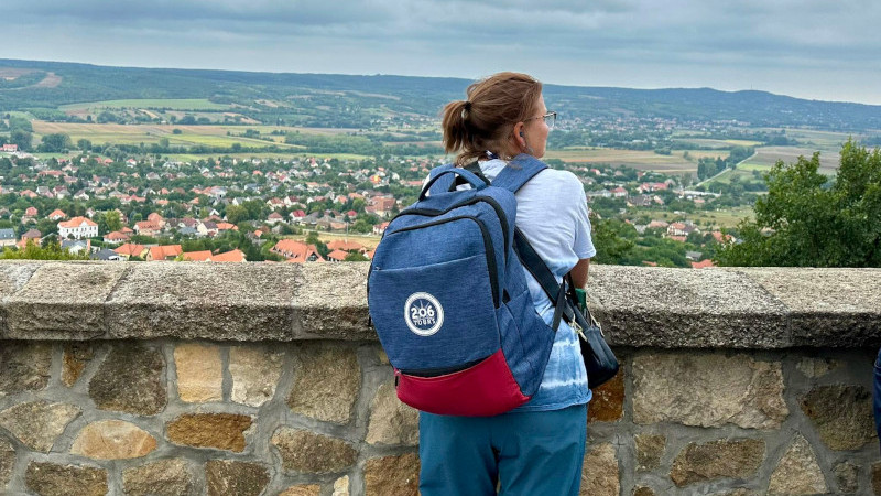 Photo of Sue Assissi at a senic overlook of a small town